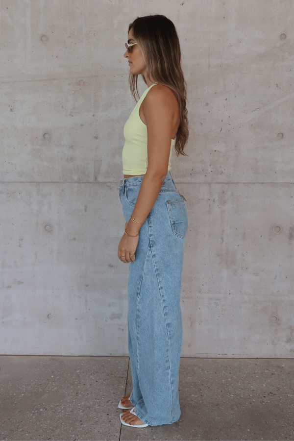 Bella Halter Tank Lemon by Sneaky Link – Soft cotton-spandex tank with deep scoop neckline and open back. A trendy, breathable piece for viral summer vibes.