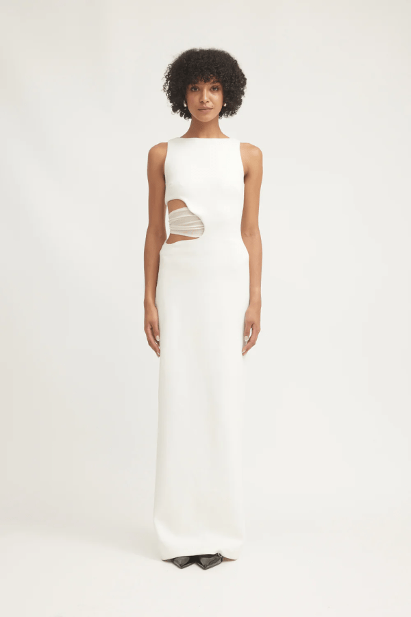 Valentina Dress Ivory by Tojhà – A sophisticated maxi in ultra-soft crepe with boat neckline, curved cut-out, and mesh detail, perfect for elegant evening occasions.