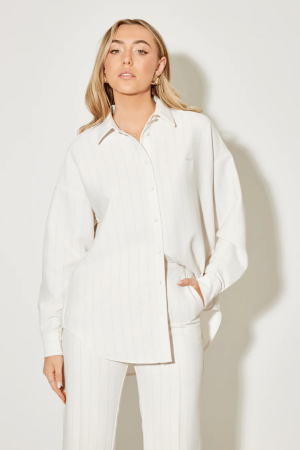 Ultimate Muse Pin Stripe Shirt Oat by Odd Muse — Classic pinstripe button-down with relaxed fit, breathable fabric, and OM embroidery for versatile, polished style.