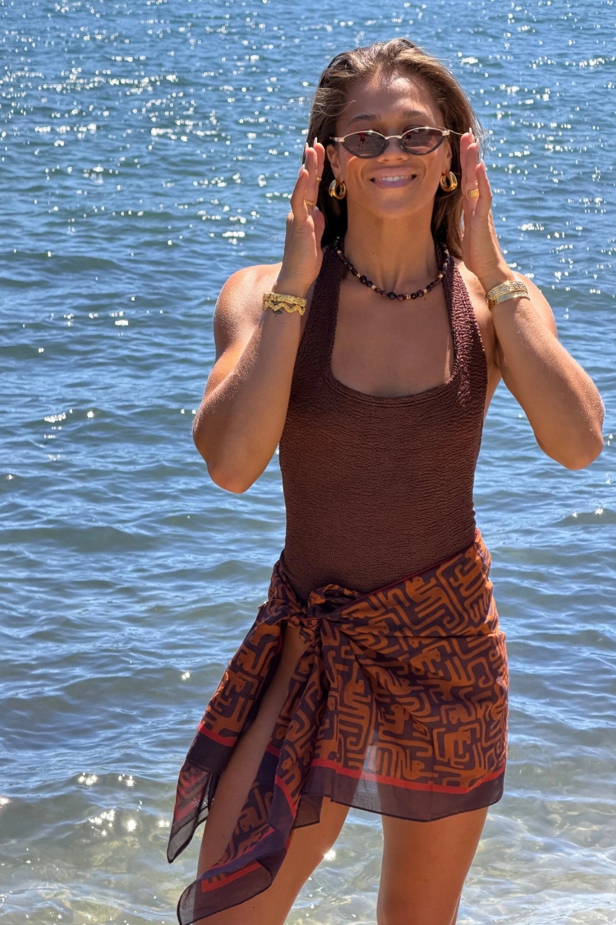 Sandy Swim by Hunza G, shimmering halter swimsuit in metallic crinkle fabric that stretches to flatter every curve.