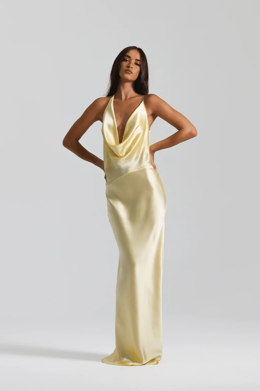 Gabi Gown Lemon by Natalie Rolt – A trendy bias-cut silk gown with an elegant asymmetric silhouette, open back, and delicate ties, perfect for special occasions.