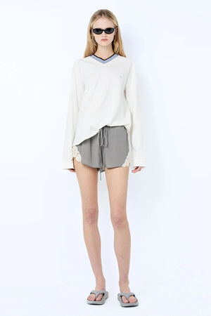 Chateau Short by Bec + Bridge, a luxe silk-viscose mini with lace detail and tie waist. Perfect for styling with matching tops.