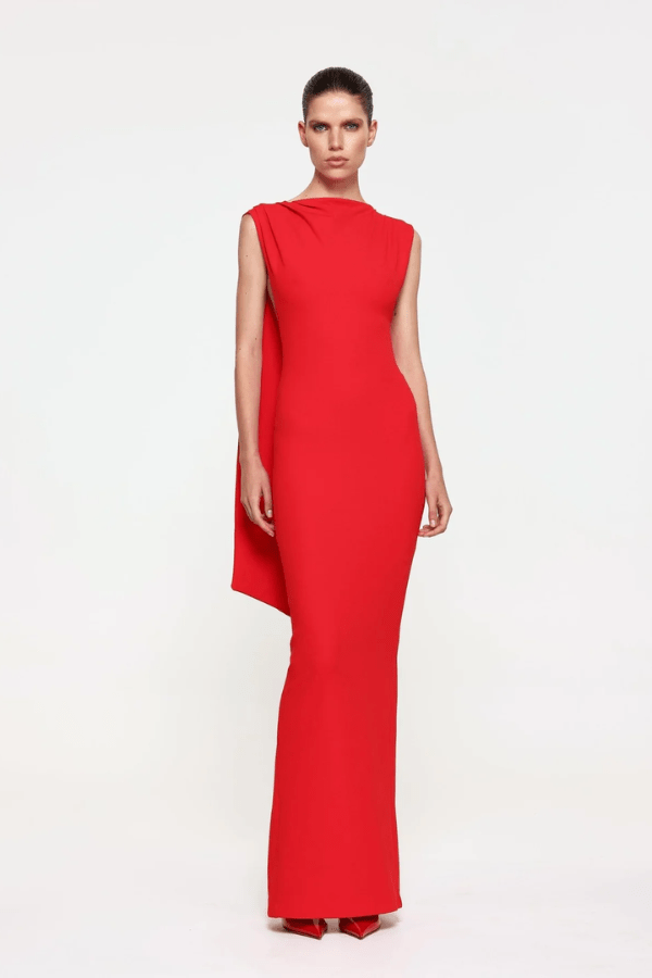 Audrey Gown Cherry Red by Effie Kats – A chic stretch crepe gown with a straight neckline, exaggerated low back, and elegant over-the-shoulder detail, perfect for special occasions.