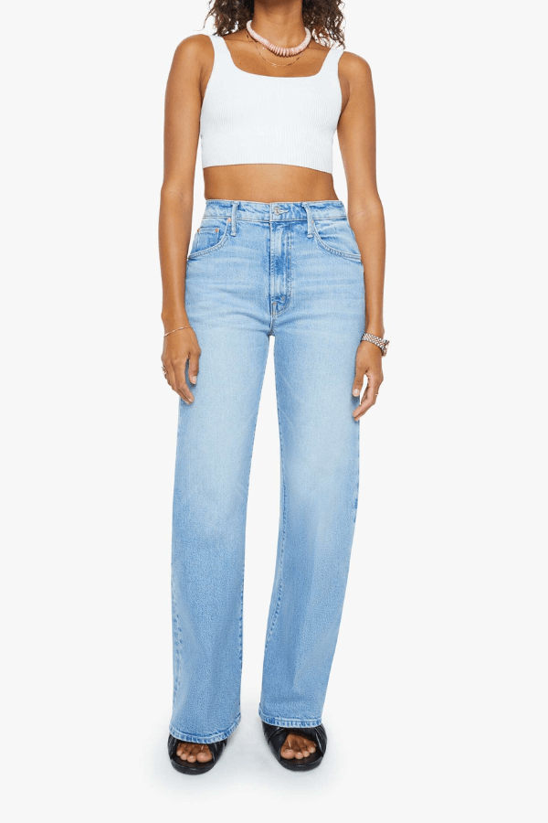 The Lasso Sneak Sow Surreal by MOTHER, trendy super high-rise wide-leg jeans with a light blue wash, whiskering, and fading. Perfect for a vintage-inspired look with a clean hem and structured fit.