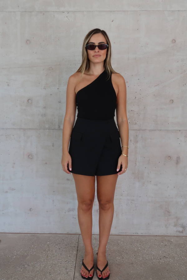 Sneaky Mini Skirt Black by Sneaky Link – A-line high-waisted mini with boned waist and flap pockets, perfect for day-to-night styling.