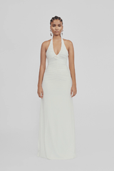 Roman Off White by Maygel Coronel – Elegant halter dress with deep V-neck, flattering ruching, and delicate 3D floral detail, perfect for refined events and celebrations.