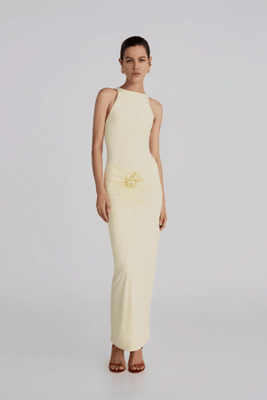 Alquimia Maxi Dress Vanilla by Maygel Coronel – A sculpting open-back maxi with ruched front and bold handmade floral detail.