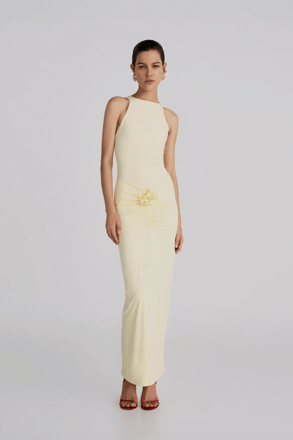 Alquimia Maxi Dress Vanilla by Maygel Coronel – A sculpting open-back maxi with ruched front and bold handmade floral detail.