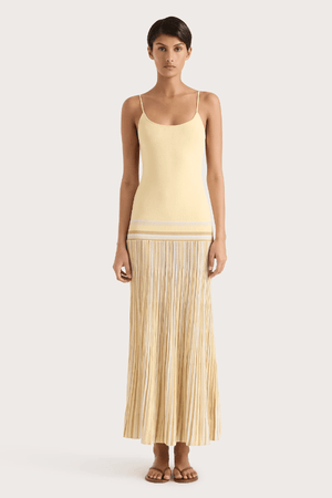 Citara Maxi Dress Butter Stripe by Faithfull the Brand – Trendy ribbed knit maxi with adjustable straps and backless tie, perfect for effortless summer elegance and beach days.