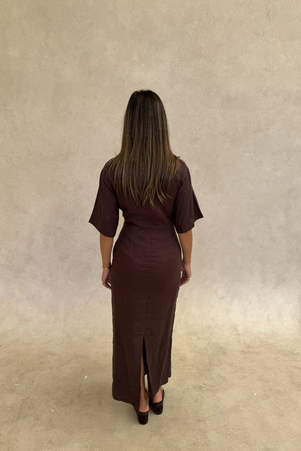 Lefka Midi Dress Chocolate by Sneaky Link – A trendy, breathable linen midi with flattering skirt tucks and button-front neckline, perfect for sunny lunches and relaxed summer days.