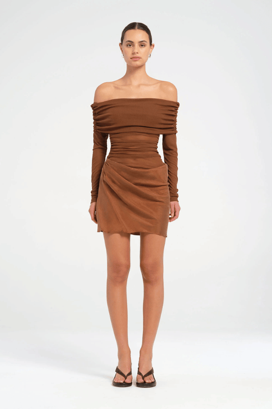 Luca Mini Dress Cocoa by Benni – A chic off-shoulder mini with sheer mesh sleeves and a draped cupro skirt, perfect for trendy evenings and stylish events.