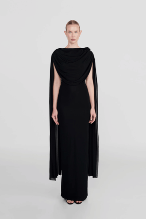 Batista Basalto by Maygel Coronel – An elegant long dress with a cowl scoop neckline, flowing shoulder sashes, and a sleek column silhouette, perfect for sophisticated evening events and making a timeless, statuesque statement.