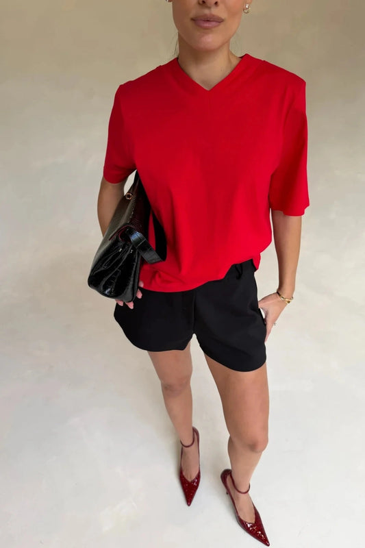 Red Olivia High V Neck Relaxed Tee with short sleeves and a loose fit on a plain background.
