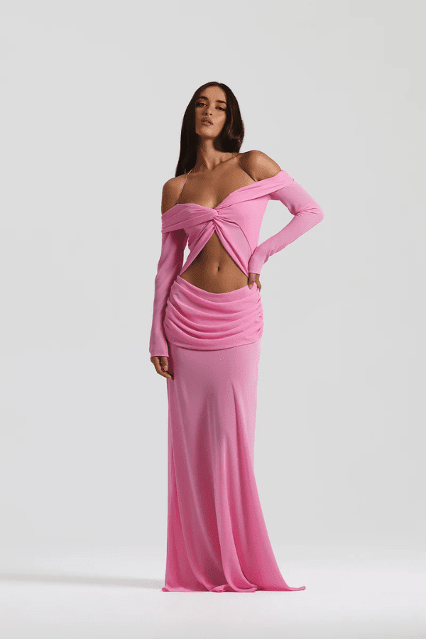 Emily Gown Candy Pink by Natalie Rolt – A trendy, ethereal georgette gown with off-shoulder draping and fluid bias cut, perfect for special occasions and statement-making moments.