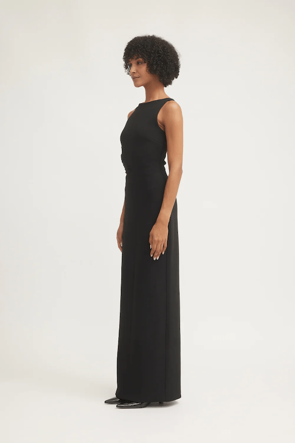 Valentina Dress Black by Tojhà – Sleek crepe maxi with curved waist cut-out and mesh detail, perfect for formal nights or chic events.