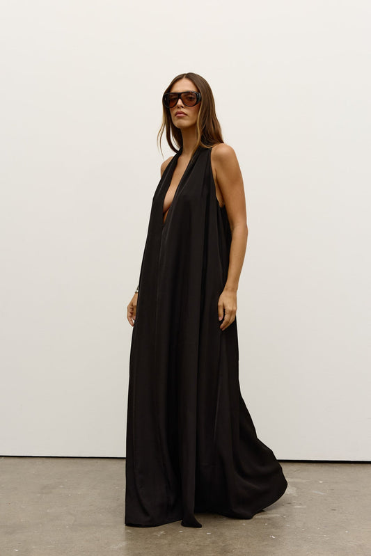 Willow Dress by Bayse, a sleek halter-neck maxi with fluid drape and side pockets, perfect for effortless day-to-evening wear.