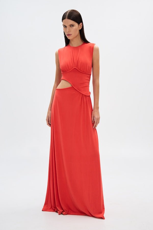 Sierra Jersey Gown Tomato Red by Misha – A trendy, sophisticated maxi with hand-twisted cords and soft pleated jersey, perfect for elegant occasions and casual glam.