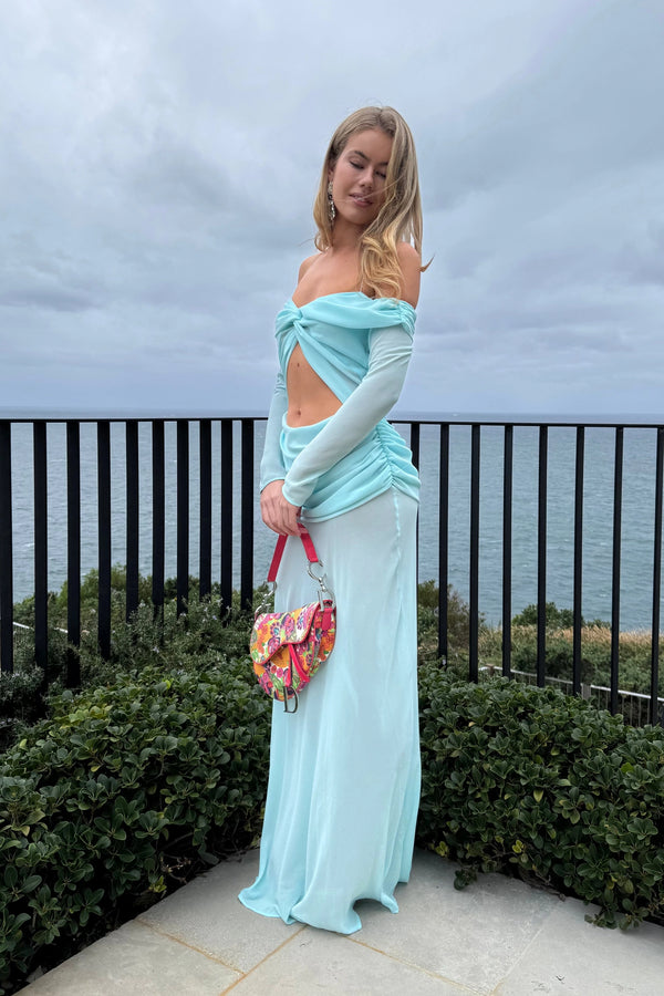 Emily Gown Baby Blue by Natalie Rolt – A trendy, ethereal gown with bias-cut georgette, off-shoulder draping, and full sleeves, perfect for romantic events.