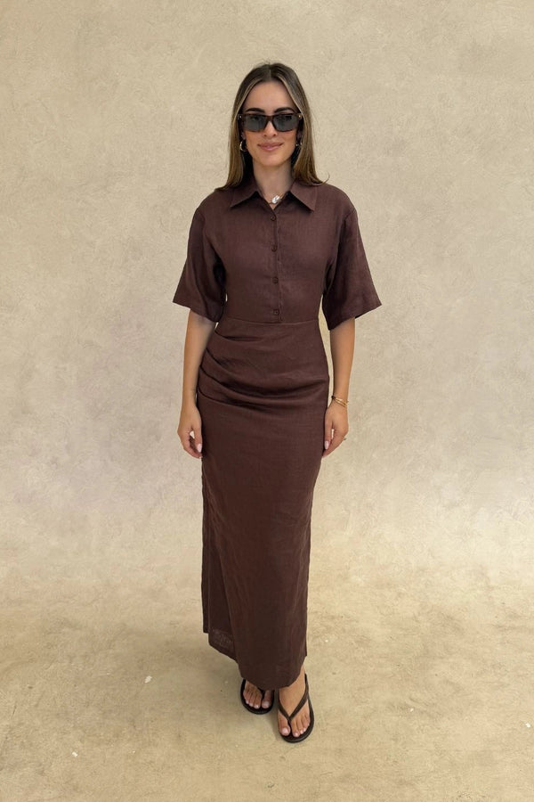 Lefka Midi Dress Chocolate by Sneaky Link – A trendy, breathable linen midi with flattering skirt tucks and button-front neckline, perfect for sunny lunches and relaxed summer days.