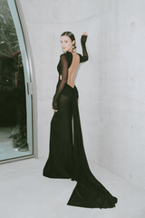 Monaco Gown Black by Effie Kats – Elegant soft mesh gown with high neckline, long sleeves, and daring open back, featuring ruching and crossed waist for a sculpted, timeless silhouette.