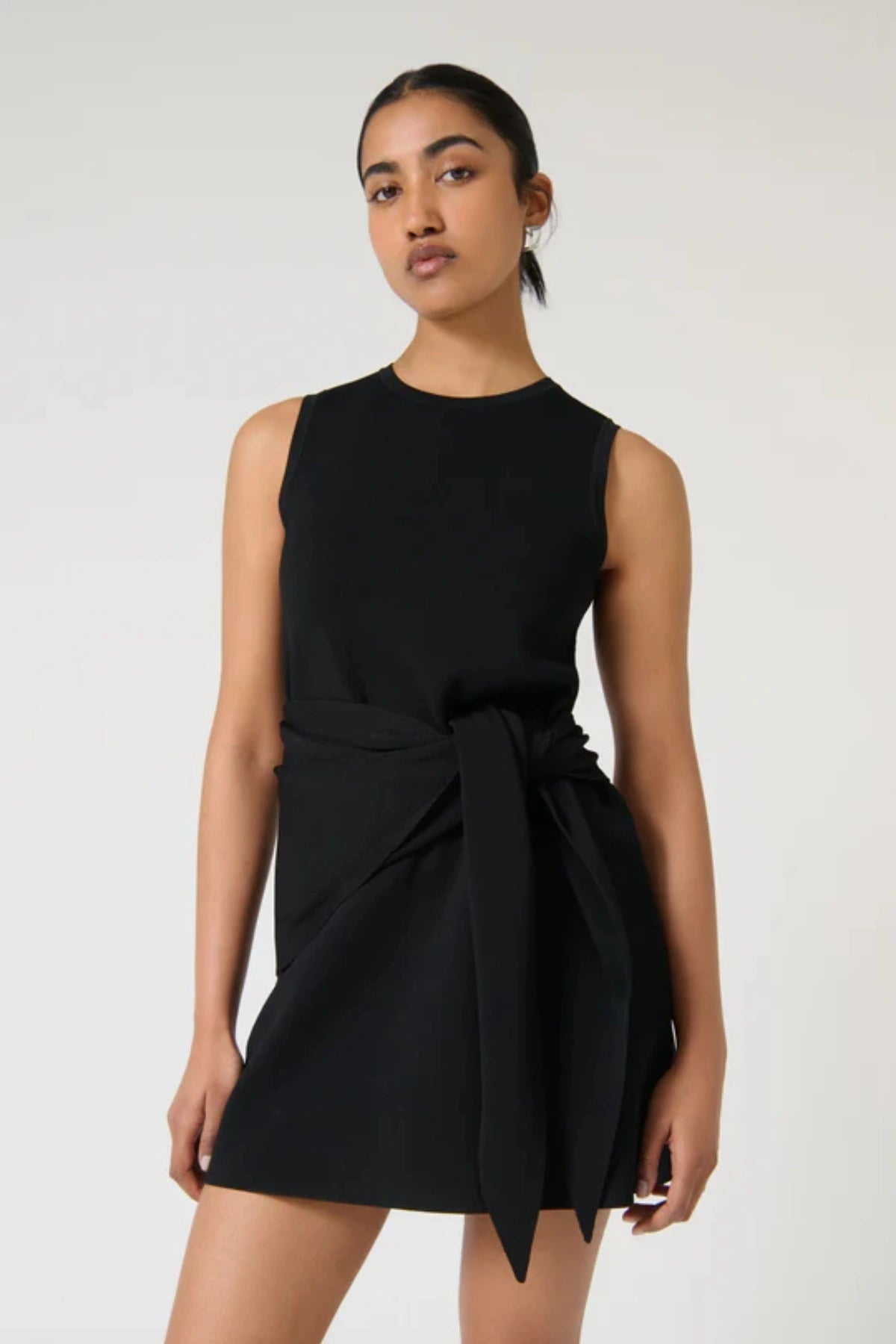 Elodia Dress – Black by Onte, a sleeveless crepe knit mini with a scarf belt. Perfect for day-to-night wear or elevated everyday style.