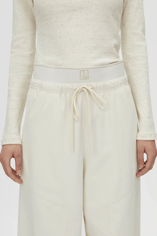 Cella Monogram Elastic Pant White by Camilla and Marc, relaxed mid-rise pants with monogram waistband, slant pockets, and panel detailing.