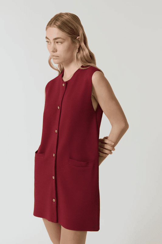Nanda Dress Burgundy by Onte – Trendy sleeveless shift in heavy Milano knit with gold knot buttons, flattering A-line silhouette, perfect for chic day or night looks.