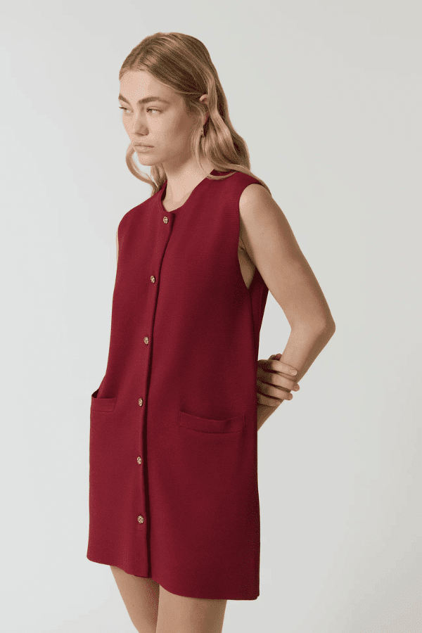 Nanda Dress Burgundy by Onte – Trendy sleeveless shift in heavy Milano knit with gold knot buttons, flattering A-line silhouette, perfect for chic day or night looks.