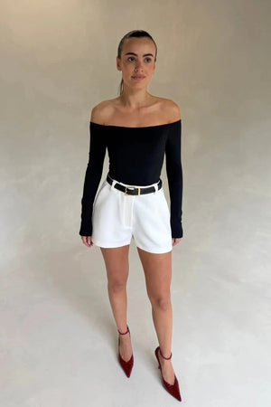 Black Henley long sleeve bodysuit with an off-shoulder neckline and fitted silhouette.