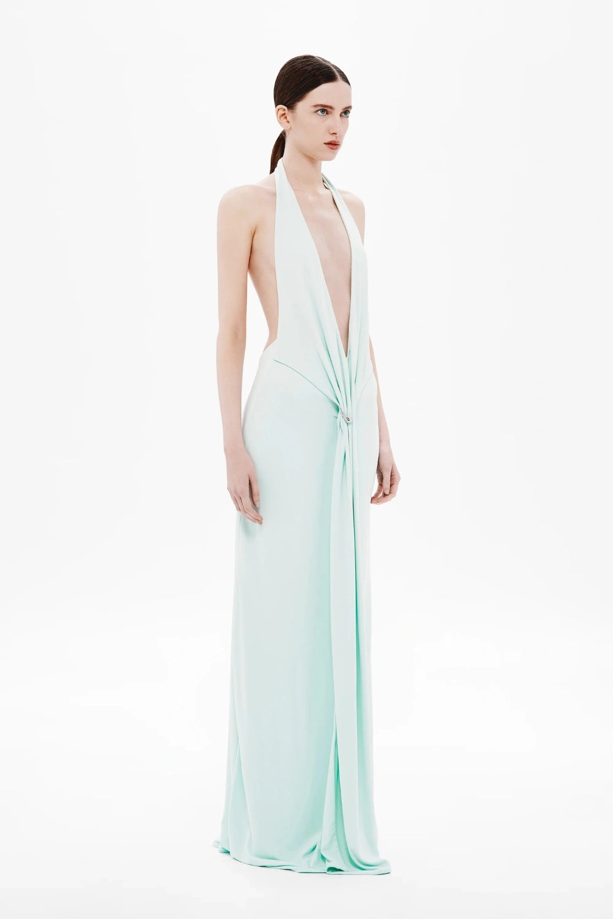 Unity Jersey Dress by Misha, a plunge-neck maxi with soft jersey drape and hardware sash. Perfect for elegant nights and formal occasions.