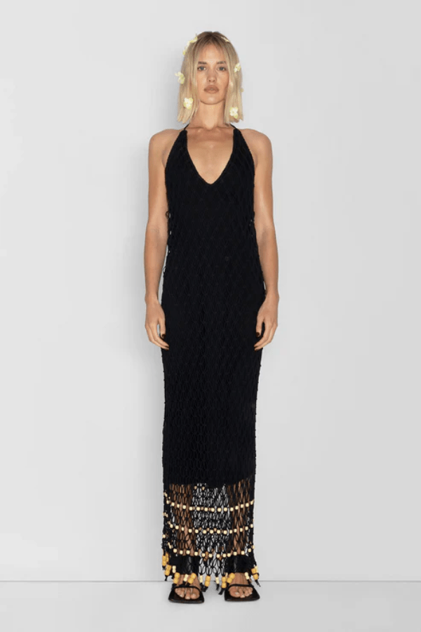 Reis Macrame Maxi Dress Noir by The Wolf Gang – Striking handmade black macrame dress with beaded hem, ideal for festivals or summer soirées.
