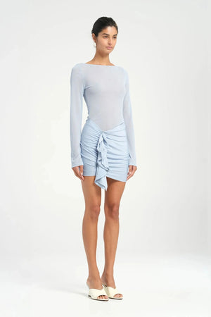 Faris Mini Dress Sky by Benni, featuring a boat neckline, long sleeves, diamante mesh bodice, and asymmetrical skirt with side drape for a graceful silhouette. Ideal for elegant evening.