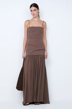 Reid Drop Waist Maxi Dress by Bec and Bridge — a milk chocolate stretch dress with a fitted bodice and sheer godet skirt, perfect for elegant evenings.