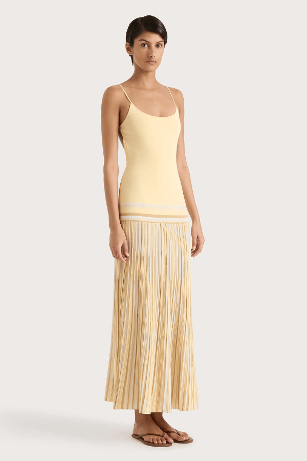 Citara Maxi Dress Butter Stripe by Faithfull the Brand – Trendy ribbed knit maxi with adjustable straps and backless tie, perfect for effortless summer elegance and beach days.