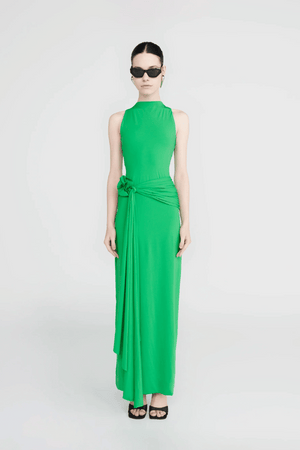 Tirso Spring Green by Maygel Coronel – Long dress with round neck, open back, ruched sash, and 3D flowers for elegant look.