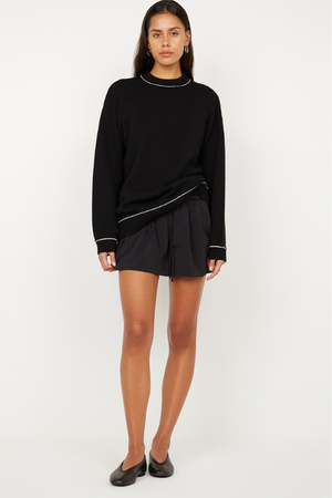 Dante Mini Skirt in Black by Bec + Bridge, a gathered stretch mini with drawstring waist. Perfect for relaxed everyday styling.