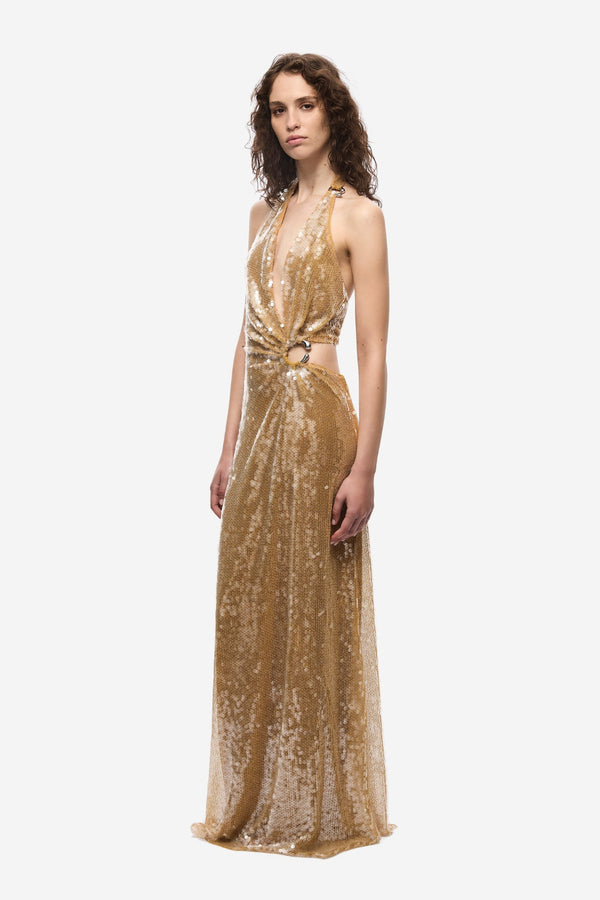 The Devon Sequin Dress by Misha, a mustard gold halter gown with cut-outs and ring detail. Perfect for parties, red carpets, or weddings.