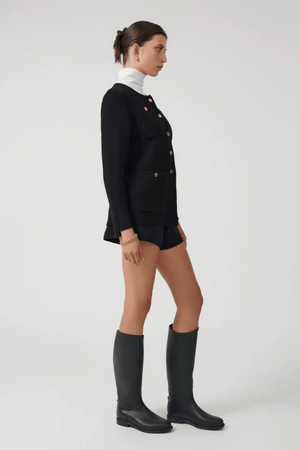 Helena Jacket Black by Onte – A stylish reinterpretation of the iconic Helena gilet, made from breathable 100% cotton yarn with a unique crochet-style stitch. Features a loose fit, gold Onte buttons, long sleeves, crew neck, and patch pockets.