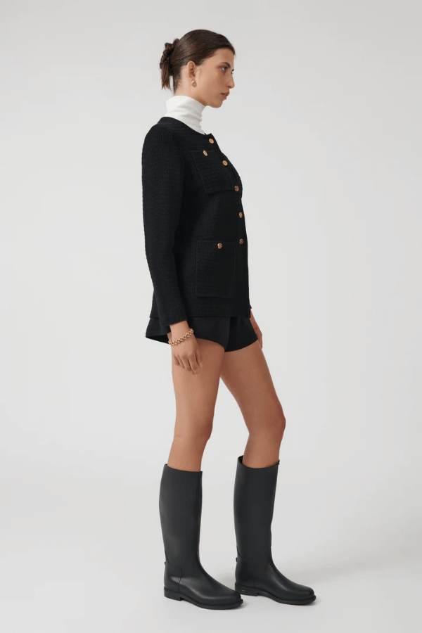 Helena Jacket Black by Onte – A stylish reinterpretation of the iconic Helena gilet, made from breathable 100% cotton yarn with a unique crochet-style stitch. Features a loose fit, gold Onte buttons, long sleeves, crew neck, and patch pockets.