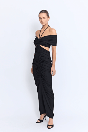 Angello Maxi Dress Black by Pfeiffer – A sleek off-shoulder maxi with cut-outs, front ruching, and an open back, perfect for formal evenings, special events, or statement celebrations.