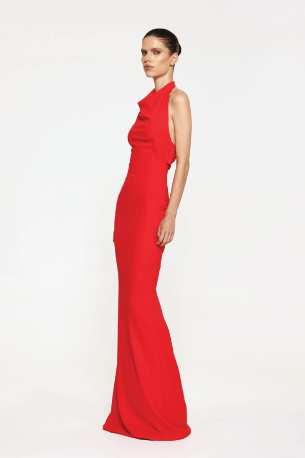Sydney Gown Red by Effie Kats – A bold and trendy stretch-jersey gown with elegant ruching and a daring thigh-high split, perfect for special evening occasions.