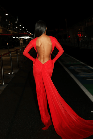 Monaco Gown Red by Effie Kats – Elegant soft mesh gown with high neckline, long sleeves, and daring open back, featuring ruching and crossed waist for a sculpted, timeless silhouette.