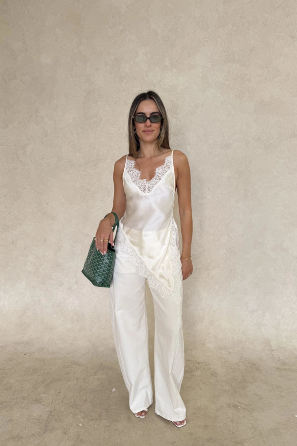 Lilah Lace Trim Top Ivory by Sneaky Link – an asymmetrical top with lace trim and V neckline. Perfect for elevated day-to-night looks.