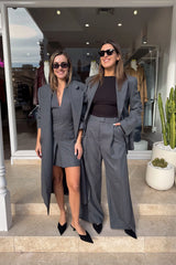 Seidler Mini Dress Dark Charcoal by Camilla and Marc – Trendy wool mini with deep V-neckline, front box pleat, and side pockets, perfect for refined daywear and polished evening looks.
