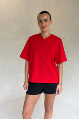 Red Olivia High V Neck Relaxed Tee with short sleeves and a loose fit on a plain background.