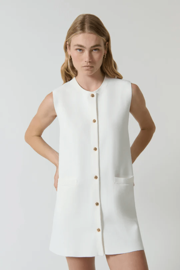 Nanda Dress White by Onte – A chic, timeless sleeveless mini shift in heavy Milano knit with gold knot buttons and welt pockets, perfect for effortless day-to-night style.