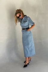 Light blue denim midi dress with short sleeves and a button-down front, styled with a relaxed fit.