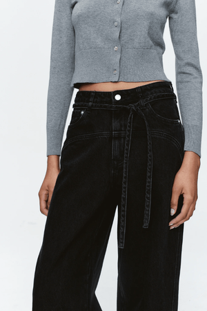 Tie Curve Seam Jean Black by Marle, trendy mid-rise jeans with unique curved seam detailing and a relaxed, wide-leg fit. Perfect for a versatile, structured look with a detachable tie belt.