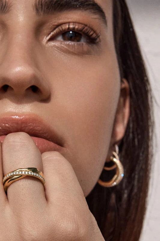 Entwined Hearts Ring by By Charlotte — a sterling silver double-band ring with CZ crystals, symbolising intertwined love and timeless elegance.