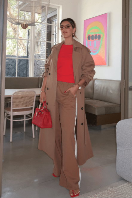 Trench Coat Tan by Sneaky Link – A timeless oversized coat in rich tan polyester, featuring classic details and subtle snake embroidery. Perfect for stylish transitional days.